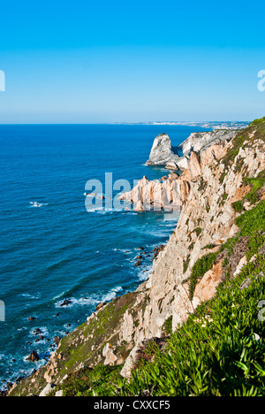 Cabo da Roca (Cape Roca) is a cape which forms the westernmost point of both mainland Portugal and mainland Europe. The cape is in the Portuguese municipality of Sintra, west of Lisbon district, and also forms the westernmost extent of the Serra de Sintra Stock Photo