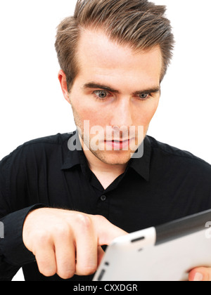 Young businessman working on an iPad, startled Stock Photo