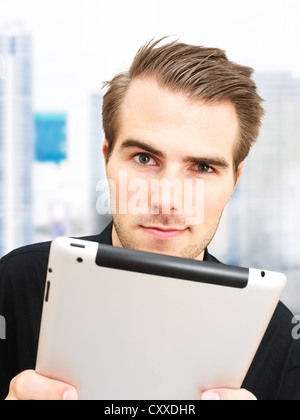 Young businessman with an iPad Stock Photo