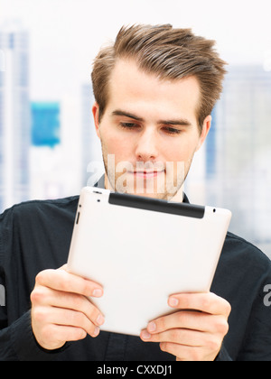 Young businessman with an iPad Stock Photo