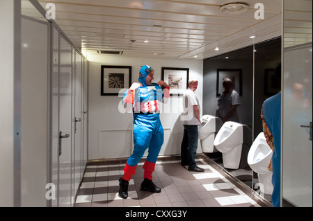 Captain America checking his clothes in a men's toilet. Stock Photo