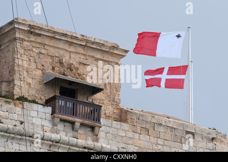 Maltese flags fly above Fort St. Angelo, Vittoriosa, Malta Stock Photo