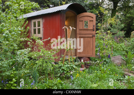 Shepherds hut in a wildflower garden for staycation glamping in the UK Stock Photo