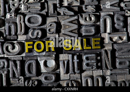 Old lead letters forming the words 'FOR SALE' Stock Photo