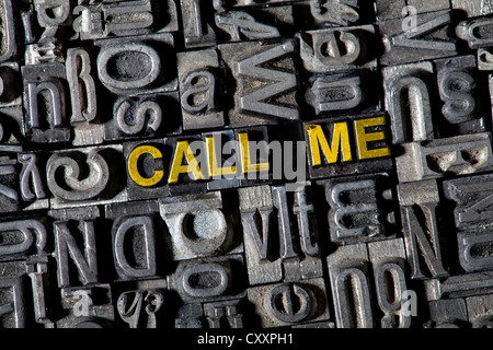 Old lead letters forming the words 'CALL ME' Stock Photo