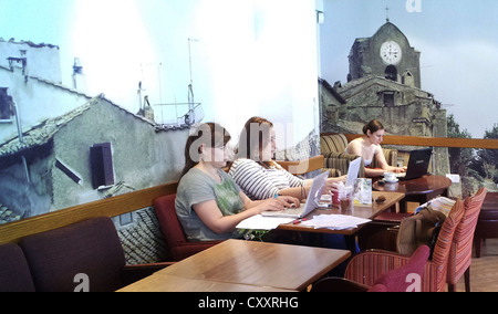 Coffee bar with young woman on social media. Stock Photo