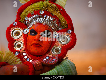 Man Dressed For Theyyam Ritual With Traditional Painting On His Face, Thalassery, India Stock Photo