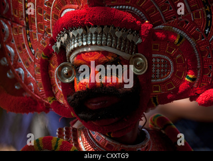 Man Dressed For Theyyam Ritual With Traditional Painting On His Face, Thalassery, India Stock Photo