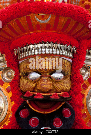 Man Dressed For Theyyam Ceremony With Traditional Painting On His Face And A Mask On His Eyes, Thalassery, India Stock Photo