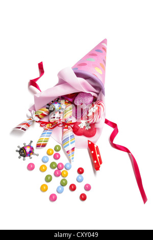 Pink schultuete or school cone with sweets spilling out Stock Photo