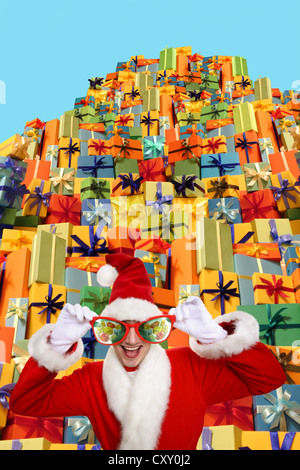 Santa Claus wearing oversized glasses, standing in front of a pile of gifts Stock Photo