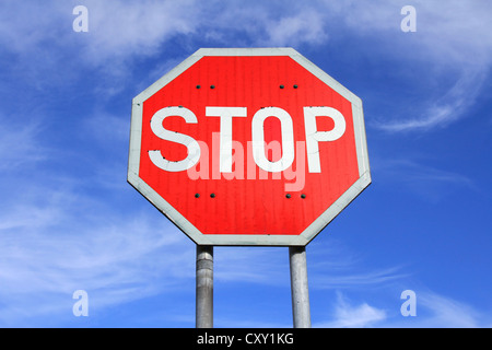 Traffic Stop Sign against Blue Sky with Some Clouds Stock Photo