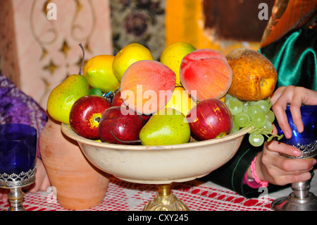 bowl full of fruits lying on the table, healthy breakfast apples, pears, peaches, grapes Stock Photo