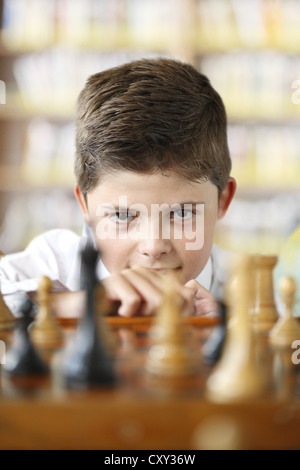 Concentrated boy playing chess Stock Photo