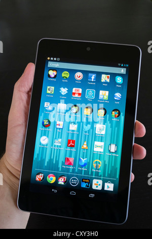 Man holding Google Nexus tablet computer running android operating system Stock Photo