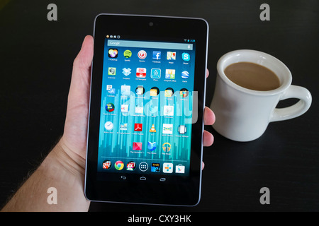 Man holding Google Nexus 7 tablet computer running android operating system Stock Photo