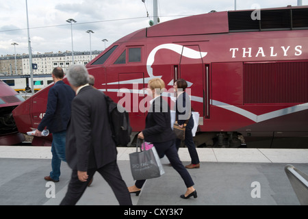Passengers on platform next to Thalys high speed train at Gare du nord station in Paris France Stock Photo