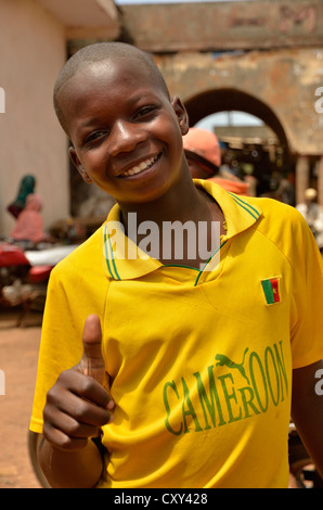 Boy in a Cameroon T-shirt making a thumbs up gesture, Ngaoundéré, Cameroon, Central Africa, Africa Stock Photo