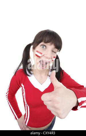 Young woman, football fan with a painted face, Austrian national flag, thumbs up Stock Photo