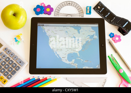 Ipad 3 with maps and school accesories on white background Stock Photo