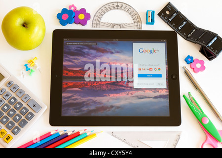 Google on Ipad 3 with school accesories on white background Stock Photo