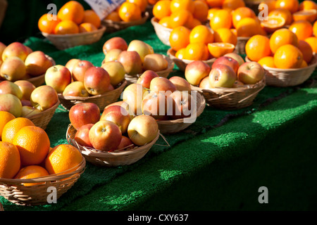 Apples and Oranges in Bowls for sale at market in North End Rd - London UK Stock Photo