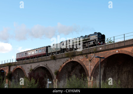 Steam locomotive No.70013 'Oliver Cromwell' crossing the viaduct at  Worcester, UK Stock Photo