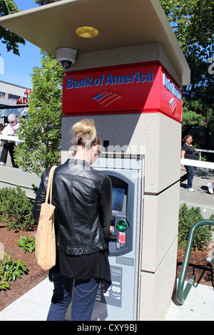 Woman using a Bank of America cash machine, USA Stock Photo