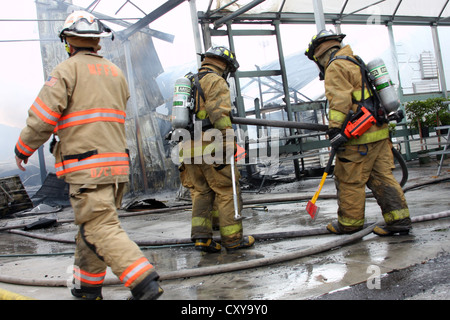 Firefighters working at a fire scene in Wisconsin Stock Photo