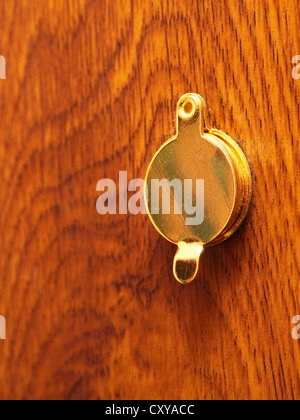 Peephole on wooden door Stock Photo