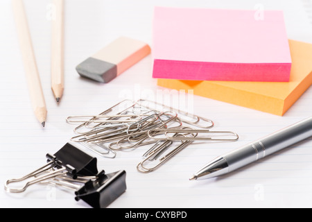 Paper pins with office supplies post-it reminder notes on notepad Stock Photo