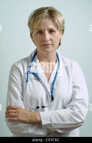 Female doctor, physician, 30-40 years, crossed arms, looking serious Stock Photo