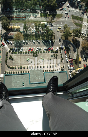 Suicide, businessman, detail, legs standing at the window of a skyscraper, looking into the depths Stock Photo