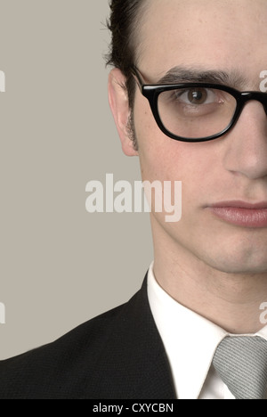 Serious young businessman wearing glasses, cropped portrait Stock Photo