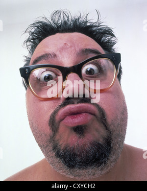 Middle aged fat man wearing glasses, unshaved, with a surprised face Stock Photo