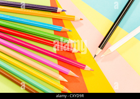 Color pencils on colorful papers close-up creativity concept Stock Photo