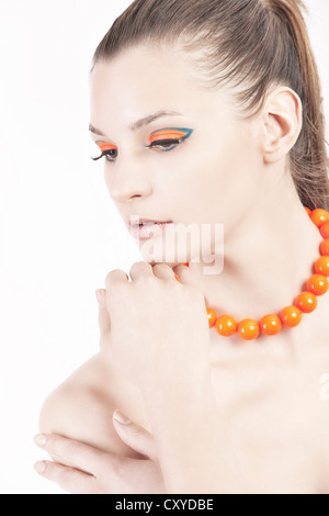 Woman with orange beaded necklace Stock Photo