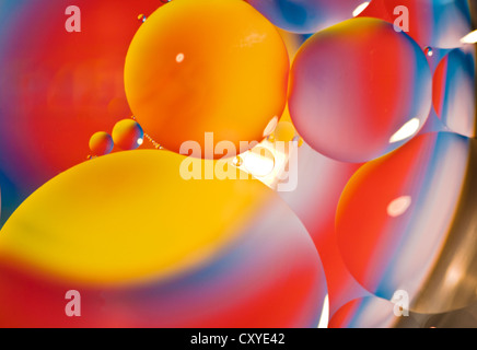 Cooking Oil in water effect. Coloured card placed below a glass table and lit from above. Stock Photo