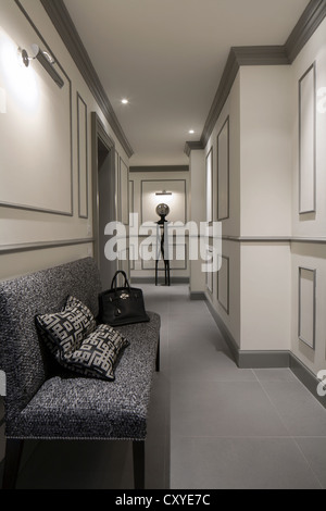 Corridor, passage way, in an elegant house in Italy with a small sofa and a Hermes bag on it Stock Photo