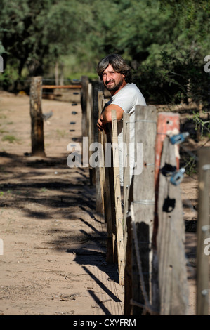 Smallholder at his fence with which he is trying to emphasise the claim to the land cultivated by him, great land owners and Stock Photo