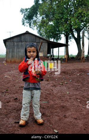 Little boy whose parents, alongside dozens of other smallholders and their families, were evicted by investors from their land Stock Photo
