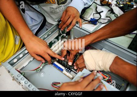 Young people assembling a computer, detailed view Stock Photo