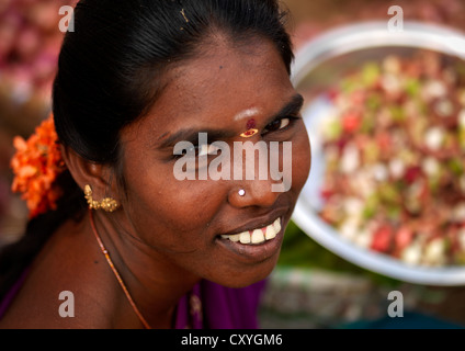 Woman With Bindi, Nose Piercing And Tied Hair With Flowers Smiling At The Camera, Madurai, India Stock Photo