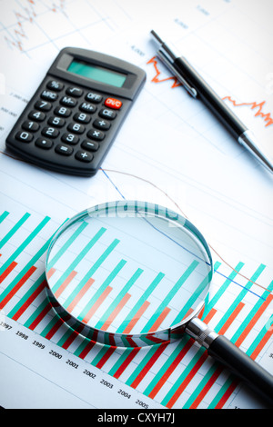 Calculator and magnifier on business graph. Business concept. Stock Photo