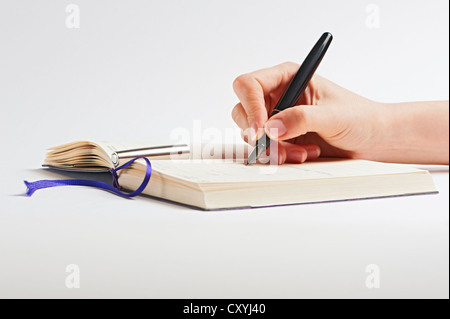 Hand with pen on white background Stock Photo