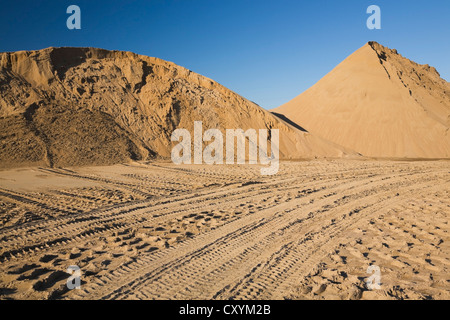 Tire tracks and mounds of sand in a commercial sandpit, Quebec, Canada Stock Photo