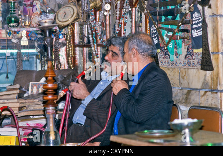 Men smoking waterpipe in a teahouse in the bazar of Isfahan, Iran, Asia Stock Photo