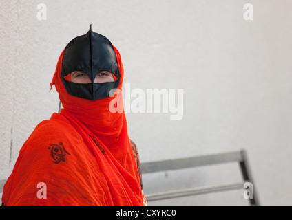 Bedouin Woman In Red Omani Burqa, Sinaw, Oman Stock Photo