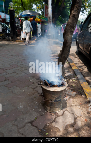 Smoking Coal Bucket in Kolkata, India Stock Photo