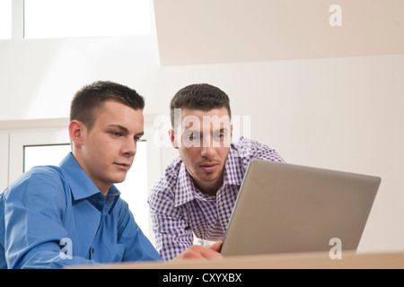 Two young colleagues working together on a computer Stock Photo